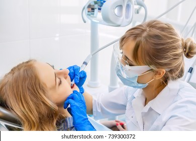 Young Professional Woman Dentist working with a Female Patient