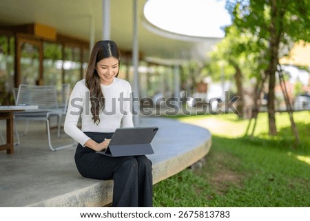 Young professional working remotely, enjoying the fresh air and greenery of a contemporary office garden