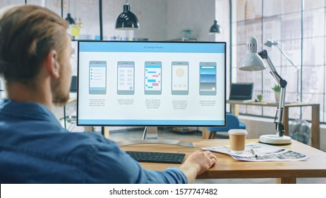 Young Professional Works on a Personal Computer at His Desk in the Creative Office. Notebook Screen Shows Mobile Phone Application Design, Software UI Development. In Background - Shutterstock ID 1577747482