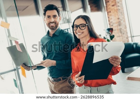 Young professionals collaborating on projects at a coworking office space showcasing teamwork, productivity, and corporate spirit