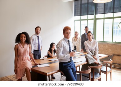 Young Professionals In A Meeting Room Looking To Camera