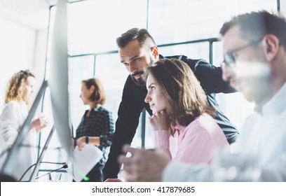 Young Professionals Work In Modern Office.Project Manager Team Discussing New Idea.Business Crew Working With Startup.Modern Desktop Computer Table,showing Presentation.Blurred,film Effect.