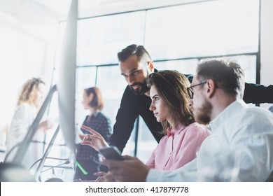 Young Professionals Work In Modern Office.Project Manager Team Discussing New Idea.Business Crew Working With Startup.Desktop Computer Table,showing Presentation, Monitor.Blurred,film Effect.