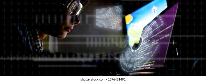young programmer in front of the laptop write a code at night network technology