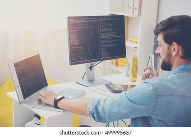 Young programmer working in an office - Shutterstock ID 499995637