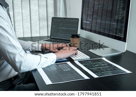Young Programmer working in software javascript computer in IT office, Writing codes and data code website and coding database technologies to find solution to problem.