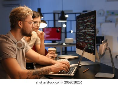 Young Programmers Working With Computer In Office At Night