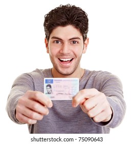 Young proud man with his European driving license