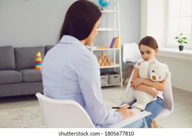 Young Psychologist Is Talking With A Child In The Room.