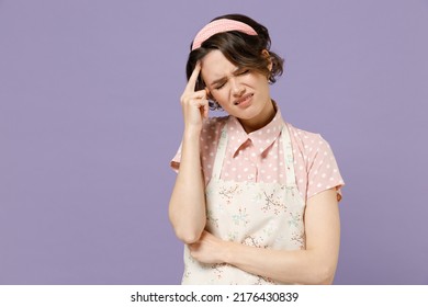 Young Puzzled Displeased Troubled Sad Housewife Housekeeper Chef Cook Baker Woman Wearing Pink Apron Prop Up Head Forehead Isolated On Pastel Violet Background Studio Portrait. Cooking Food Concept.