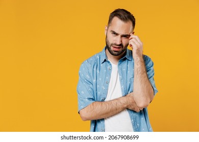 Young puzzled embarrassed bewildered caucasian man 20s wearing blue shirt white t-shirt prop up forehead hold head say oops isolated on plain yellow background studio portrait People lifestyle concept - Shutterstock ID 2067908699