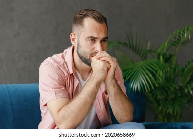 Young puzzled minded serious preoccupied sad depressed caucasian man 20s in casual clothes k sitting on blue sofa at home flat indoors rest relax on weekends free time. People lounge lifestyle concept - Powered by Shutterstock