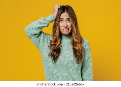 Young puzzled sad disappointed uncertain caucasian woman 30s in green knitted sweater scratch hold head look camera isolated on plain yellow color background studio portrait. People lifestyle concept - Shutterstock ID 2132326657