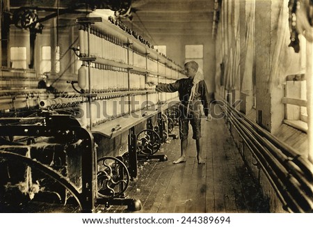 Young Raoul Julien had already worked for two years in the mule-spinning room in Chace Cotton Mill, Burlington, Vermont, when Lewis Hine took this photo in 1909.