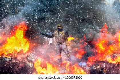 Young rebel calls for a rally against the tyranny of the authorities among the burning of the capital of the European quarter. Burning tires rekolesa from Molotov cocktails, smoke and soot fire - Shutterstock ID 1566872020
