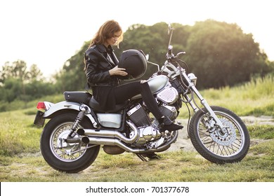 Young Rebel Woman Sitting On Her Motorcycle In The Nature