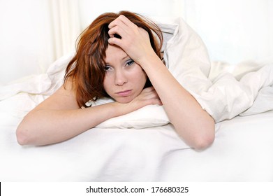 Young Red Hair Woman On Bed Waking Up With Hangover And Headache