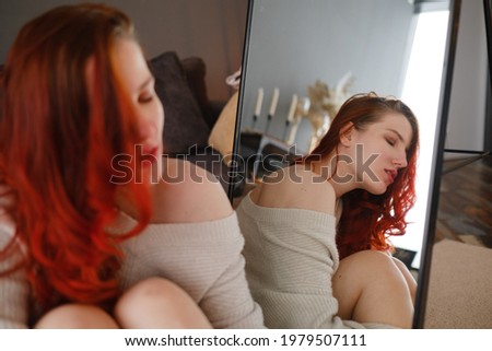 Young redhair woman spending free time home. Serene mornings. The concept and idea of a peaceful morning, meditation and relaxation on a weekend day
