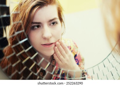 Young Red-haired Girl Doing Morning Makeup Before The Mirror