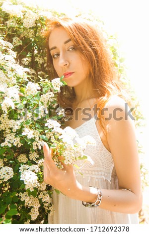 Similar – Woman posing in field of white flowers