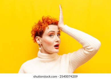 young red-haired woman with curly hair forgot and remembers and shows facepalm on yellow isolated background, girl with beautiful make-up makes mistake and worries - Powered by Shutterstock