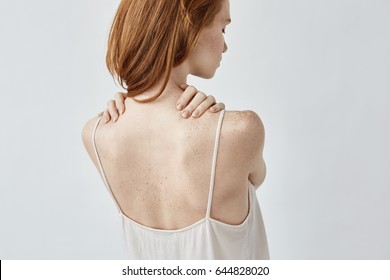 Young Redhead Girl With Freckles Posing Back To Camera.