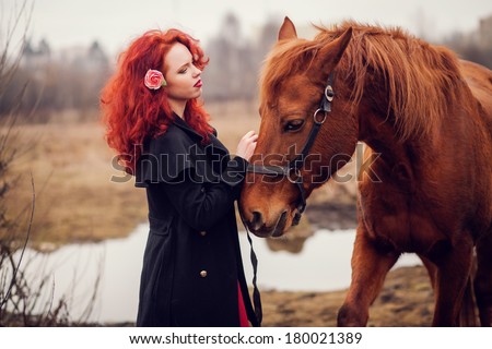 Young redhead girl and horse