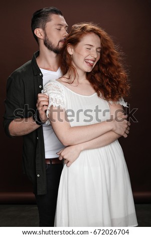 Similar – Image, Stock Photo Studio portrait of a young couple hugging