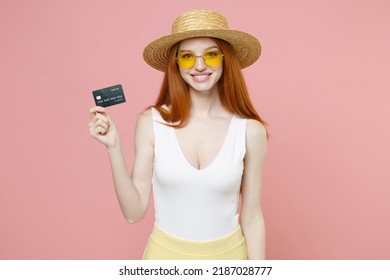 Young Redhead Rich Happy Caucasian Woman 20s Ginger Long Hair In Straw Hat Glasses Summer Clothes Holding Credit Bank Card Shopping Online Look Overhead Isolated On Pink Background Studio Portrait