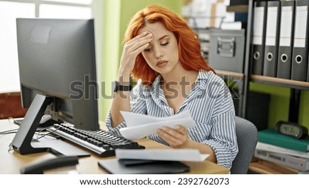 Young redhead woman business worker using computer opening envelope letter at office