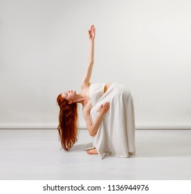 Young Redhead Woman Does Stretching And Yoga Poses, Dancing Contemporary Dance, Posing In Studio, . Copy Space