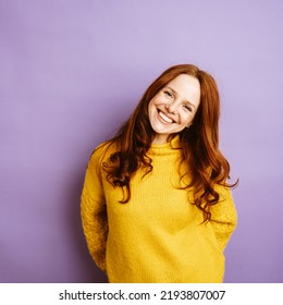 Young redhead woman laughing at camera