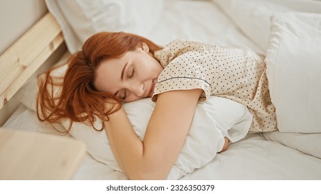 Young redhead woman lying on bed hugging pillow sleeping at bedroom - Powered by Shutterstock