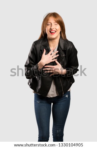 Young redhead woman smiling a lot over isolated grey background