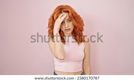 Young redhead woman stressed standing over isolated pink background