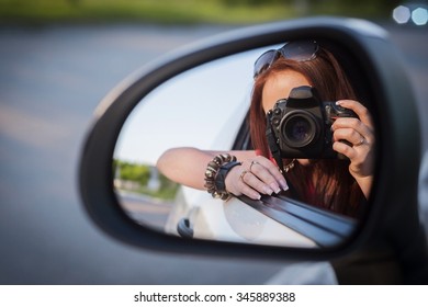 Young Redhead Woman Take Selfie On Car Wing Mirror