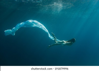 Young Redhead Woman Underwater