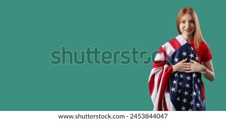 Young redhead woman with USA flag on green background with space for text