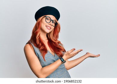 Young Redhead Woman Wearing Fashion French Look With Beret Inviting To Enter Smiling Natural With Open Hand 