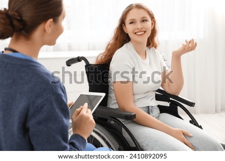 Similar – Image, Stock Photo Young woman in wheelchair with loyal dog in kitchen