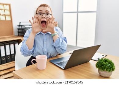 Young Redhead Woman Working At The Office Using Computer Laptop Smiling Cheerful Playing Peek A Boo With Hands Showing Face. Surprised And Exited 