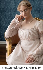 A Young Regency Woman In A Pink Dress In A Regency Room