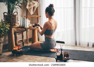 Young Relaxed Woman Doing Yoga At Home With Candles And Incense. 