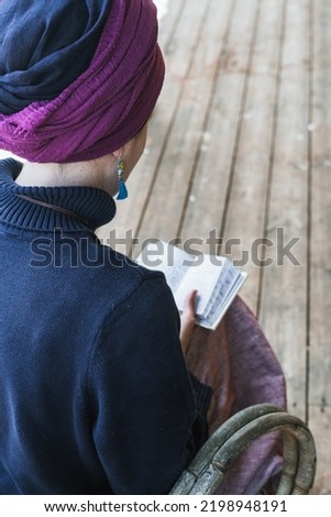 Young religious Jewish woman with a headscarf on her head prays with a religious prayer book (50)