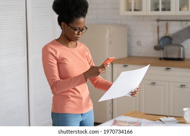 Young Remote Worker Female Take Photo Of Document Draft On Smartphone To Send Project Plan To Client Or Boss. Black Freelancer Designer Work From Home. Architect Woman Busy With Papers For Building