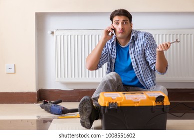 Young Repairman Contractor Repairing Heating Panel 