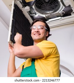 Young repairman repairing ceiling air conditioning unit - Shutterstock ID 2213246777