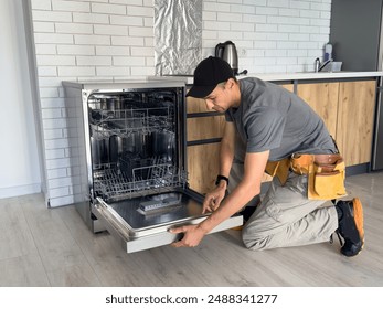 Young Repairman Service Worker Repairing Dishwasher Appliance In Kitchen - Powered by Shutterstock