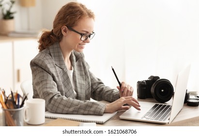 Young Reporter Transfering Image Data From Camera To Laptop, Ready To Write New Article