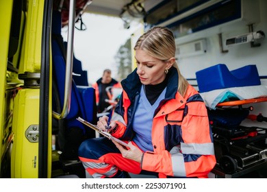 Young rescuer doctor checking equipment in ambulance car. - Powered by Shutterstock